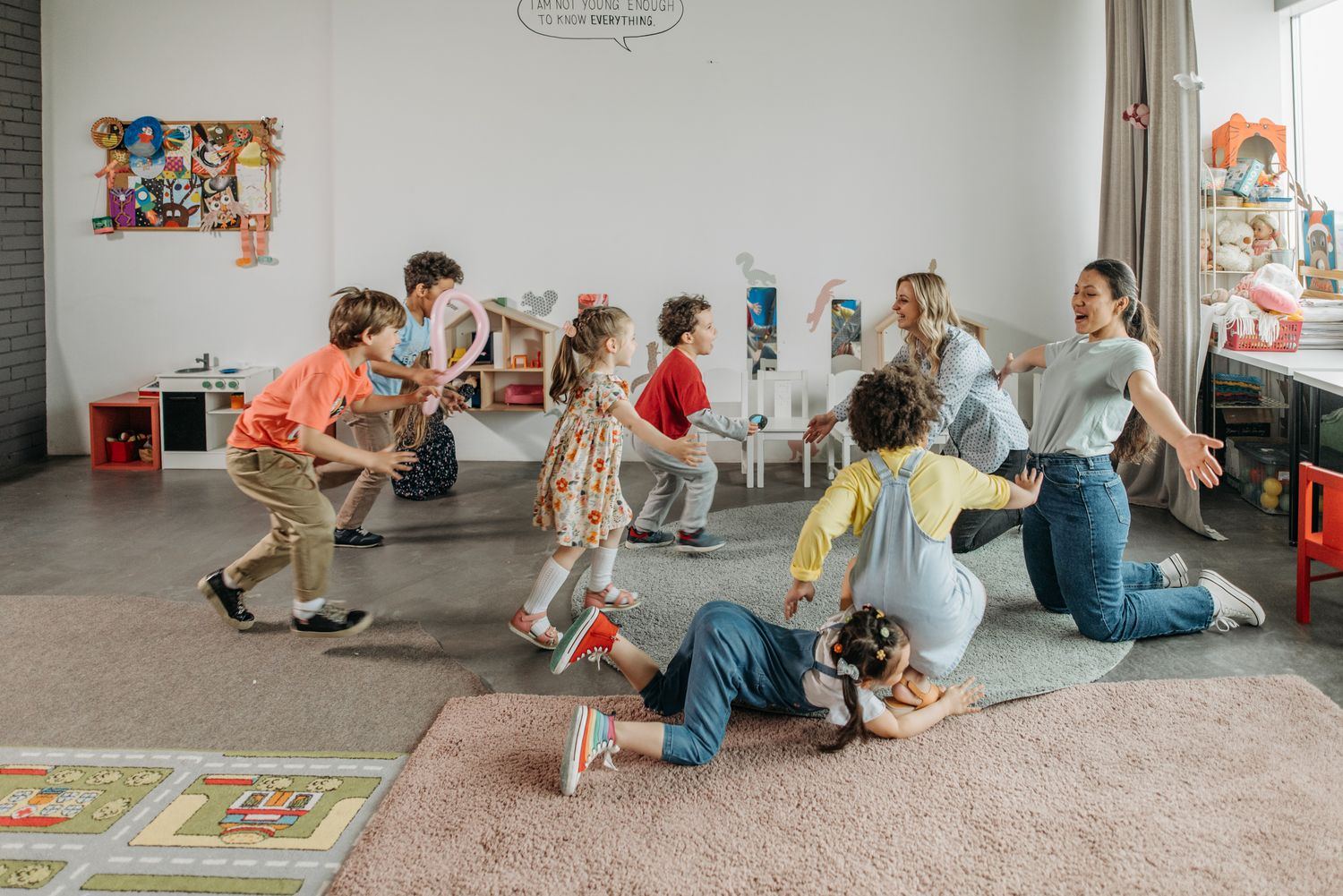 Children and educators playing together in a bright Little Munchkin classroom
